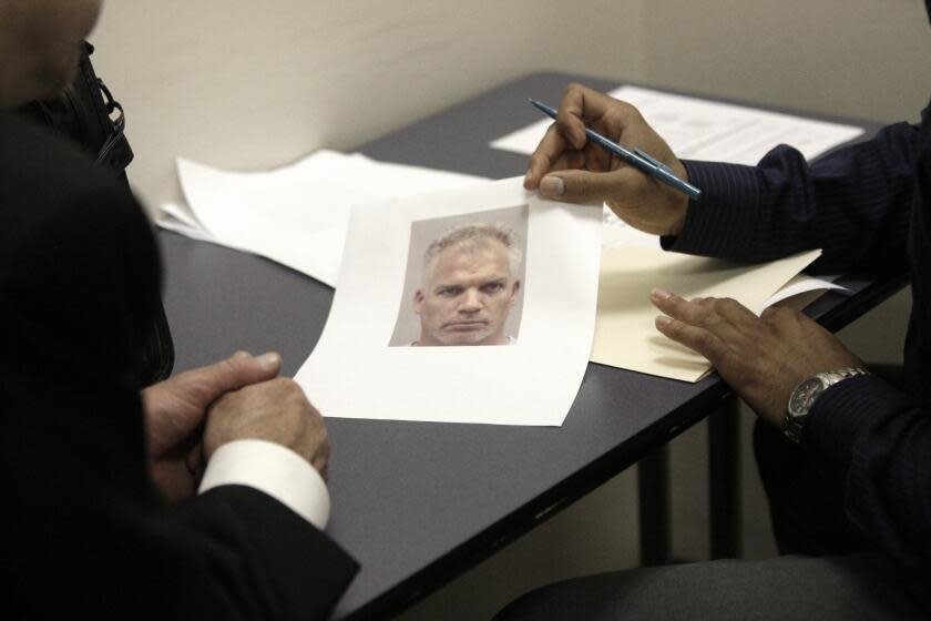 In a new type of police lineup, a Dallas police officer shows a victim of a robbery a single photo of a suspect in an interview room at police headquarters in Dallas, Texas, Tuesday, Aug. 18, 2009. The police department in Dallas has become the nation's largest force to use sequential blind lineups, a widely praised technique that experts said should reduce mistakes made by eyewitnesses trying to identify suspects. (AP Photo/LM Otero)