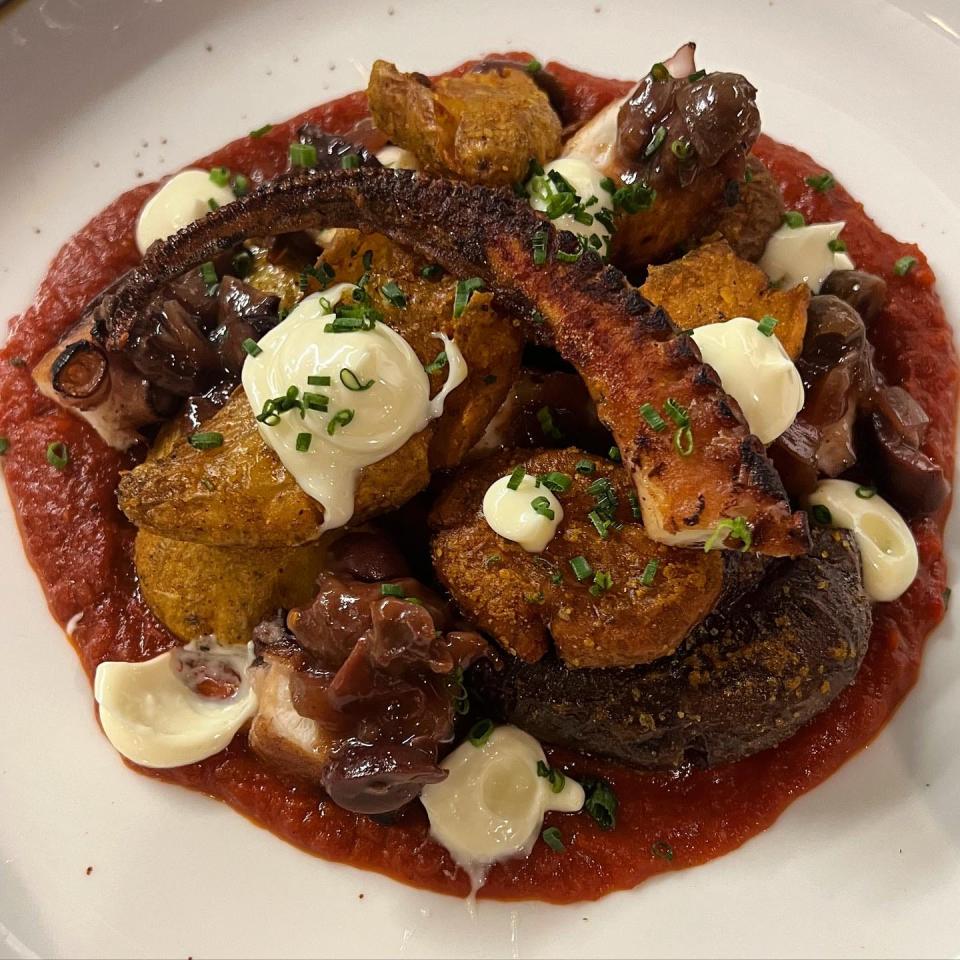 Seared octopus with smashed fingerlings, chicken salt, bravas sauce, Kalamata olive, red onion jam and yuzu aioli at Harvey's restaurant in Louisville.