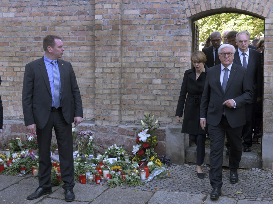 German President Frank-Walter Steinmeier, front right, and his wife Elke Buedenbender leave a synagogue in Halle, Germany, Thursday, Oct. 10, 2019. A heavily armed assailant ranting about Jews tried to force his way into a synagogue in Germany on Yom Kippur, Judaism's holiest day, then shot two people to death nearby in an attack Wednesday that was livestreamed on a popular gaming site. (AP Photo/Jens Meyer)