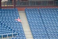 <p>A lone fan sits in the stands during the Summer Camp game between the Baltimore Orioles and the Philadelphia Phillies on July 19 at Citizens Bank Park in Philadelphia.</p>