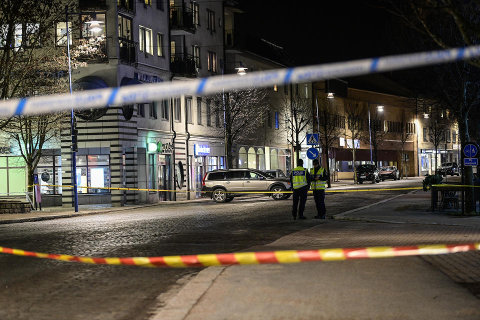 Police are seen in the area after several people were attacked in Vetlanda, Sweden, Wednesday, March 3, 2021. Swedish police say a man has assaulted at least eight people in a southern Sweden town, and that the case was being investigated as ”a suspected terrorist crime.” Police said a man in his 20s attacked people in the small town of Vetlanda, about 190 kilometers (118 miles) southeast of Goteborg, Sweden’s second largest city. (Mikael Fritzon/TT News Agency via AP)