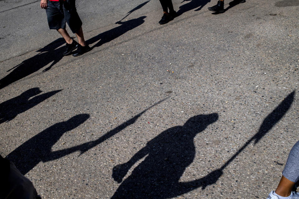 General Motors employees chant in unison "No contract! No work!" as they circle at one of the Flint Assembly Plant entrance, blocking through traffic during the fourth day of the national UAW strike against GM on Thursday, Sept. 19, 2019 in Flint. The United Auto Workers union and its roughly 49,000 members at GM plants in the U.S. have been on strike since Monday, Sept. 16 because contract negotiations with the automaker had broken down. It's the first national UAW strike since 2007, when GM workers were out for two days. (Jake May/The Flint Journal via AP)