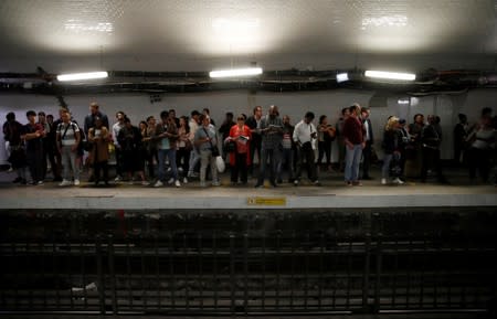 Commuters wait to board a metro at the Gare du Nord subway station during a strike by all unions of the Paris transport network (RATP) against pension reform plans in Paris