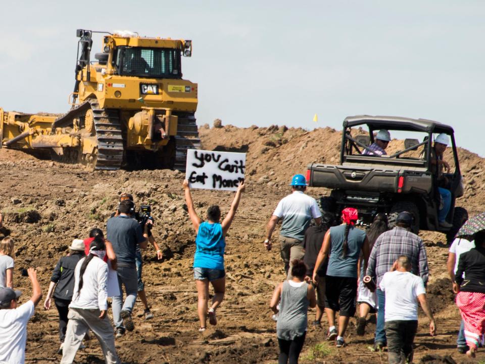 Native American protestors and their supporters are confronted by security during a demonstration against work being done for the Dakota Access Pipeline (DAPL) oil pipeline, near Cannon Ball, North Dakota, September 3, 2016.