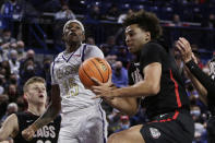 Alcorn State guard Dominic Brewton (15) and Gonzaga forward Anton Watson, right, go after a rebound during the second half of an NCAA college basketball game, Monday, Nov. 15, 2021, in Spokane, Wash. (AP Photo/Young Kwak)