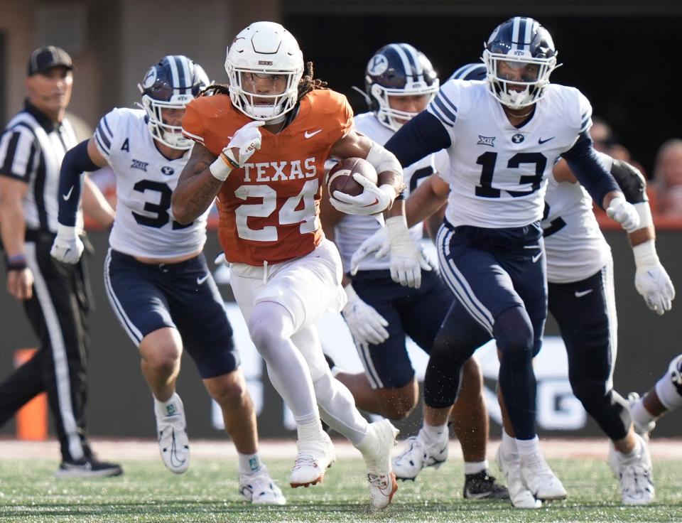 Texas running back Jonathon Brooks runs past Brigham Young defenders during last week's game in Austin. Brooks ranks second in the Big 12 in rushing with 923 yards.