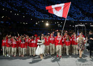 LONDON, ENGLAND - JULY 27: Simon Whitfield of the Canada Olympic triathlon team carries his country's flag during the Opening Ceremony of the London 2012 Olympic Games at the Olympic Stadium on July 27, 2012 in London, England. (Photo by Cameron Spencer/Getty Images)