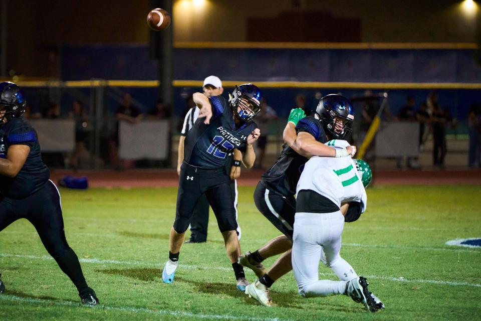 Paradise Honors Panthers quarterback Gage Baker (12) passes against the Thatcher Eagles at Paradise Honors High School in Surprise on Friday, Aug. 18, 2023. Alex Gould/Special to The Republic