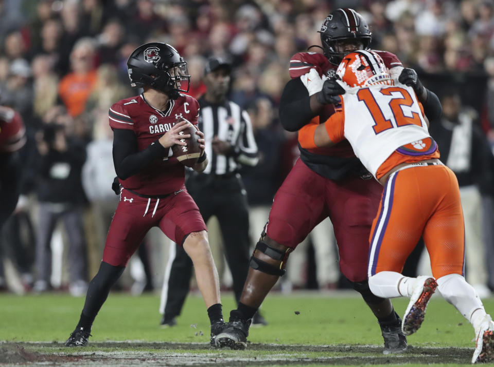 South Carolina quarterback Spencer Rattler (7) drops back to pass during the first half of the team's NCAA college football game against Clemson, Saturday, Nov. 25, 2023, in Columbia, S.C. (AP Photo/Artie Walker Jr.)