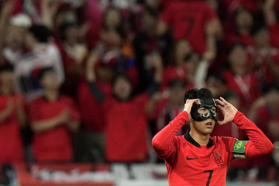 South Korea's Son Heung-min adjusts his face protector during the World Cup group H soccer match between South Korea and Ghana, at the Education City Stadium in Al Rayyan , Qatar, Monday, Nov. 28, 2022. (AP Photo/Luca Bruno)