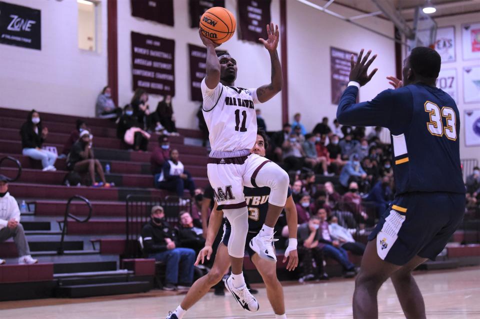 McMurry's Remy Minor (11) goes up for a shot during Saturday's American Southwest Conference game against East Texas Baptist.