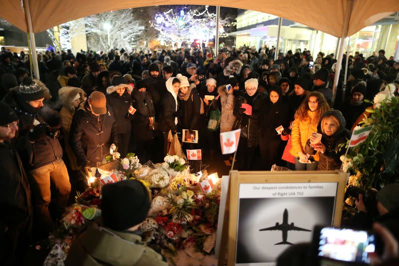 Mourners attend a memorial for the victims of a Ukrainian passenger jet which was shot down in Iran