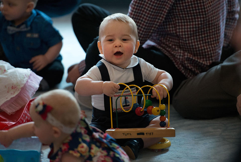 WELLINGTON, NZ - APRIL 09:  Prince George of Cambridge plays during a Plunket nurse and parents group visit at Government House on April 9, 2014 in Wellington, New Zealand. Plunket is a national not-for-profit organization that provides care for children and families in New Zealand. The Duke and Duchess of Cambridge are on a three-week tour of Australia and New Zealand, the first official trip overseas with their son, Prince George of Cambridge.  (Photo by Marty Melville-Pool/Getty Images)