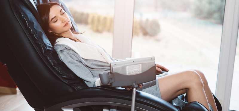 Woman reclining in a massage chair.