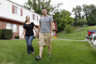 In this Monday, Aug. 20, 2012 photo, Marine Sgt. Ron Strang, right, walks with his girlfriend, Monica Michna, in the yard by his home in Jefferson Hills, Pa., just south of Pittsburgh. In 2008, the federal government created AFIRM, the Armed Forces Institute of Regenerative Medicine, a network of top hospitals and universities around the country, and gave $300 million in grants to spur new treatments using cell science and advanced plastic surgery. Strang is among those benefiting. The 28-year-old former Marine sergeant from Pittsburgh lost half of his left thigh muscle to shrapnel, leaving too little to stabilize his gait. "My knee would buckle and I'd fall over," he said. Now, after an experimental cell treatment at the University of Pittsburgh Medical Center, "I'm able to run a little bit" and play a light football game with friends, he said. "It's been a huge improvement." (AP Photo/Keith Srakocic)