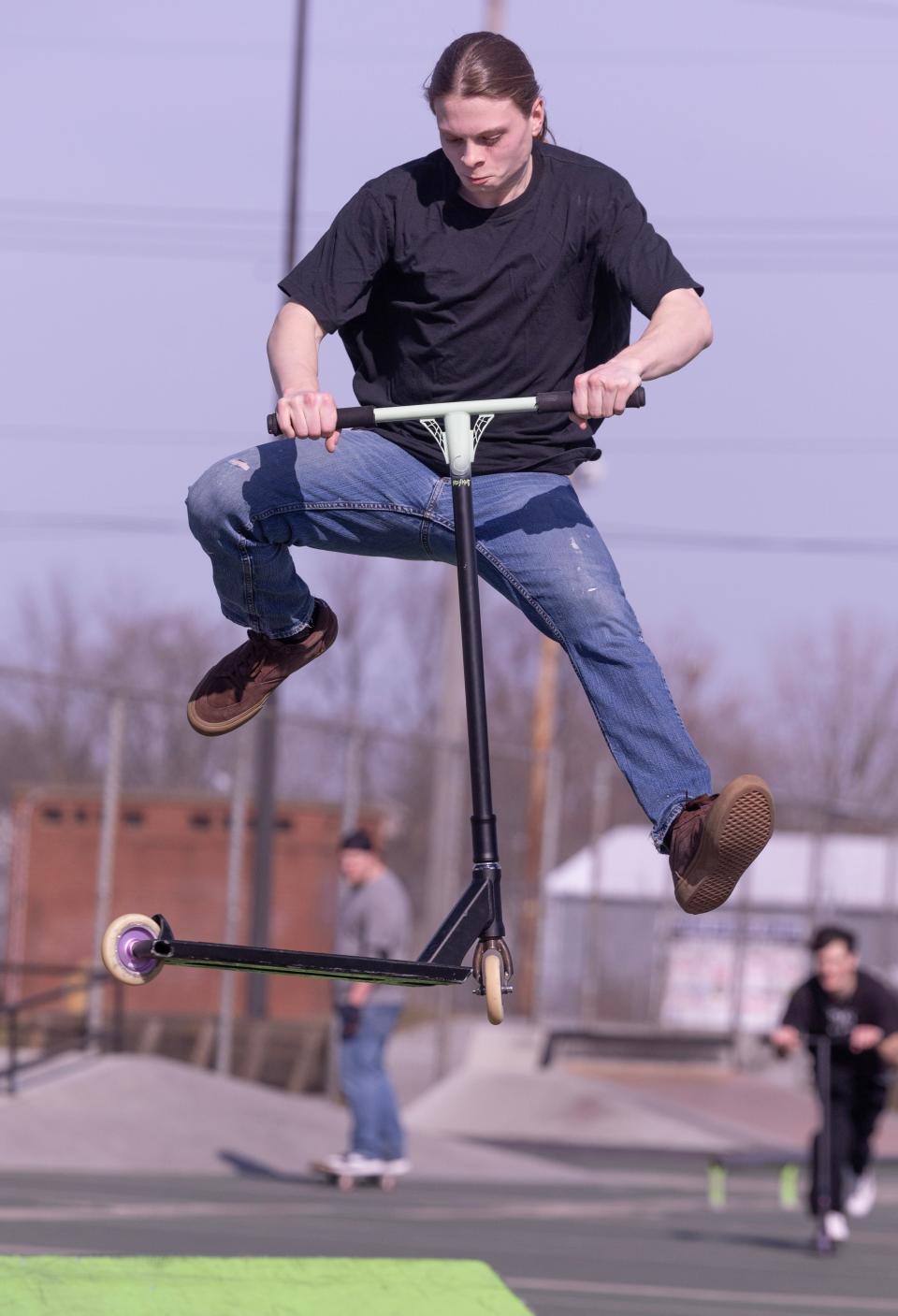 Jaden Mayo of Canton does a double tail whip on his scooter at the 9th Street DIY skate park in Canton.