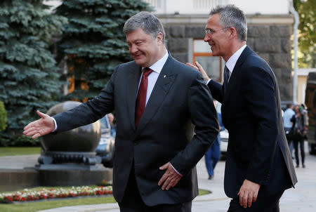 Ukrainian President Petro Poroshenko and NATO Secretary General Jens Stoltenberg walk before a meeting in Kiev, Ukraine, July 10, 2017. REUTERS/Valentyn Ogirenko