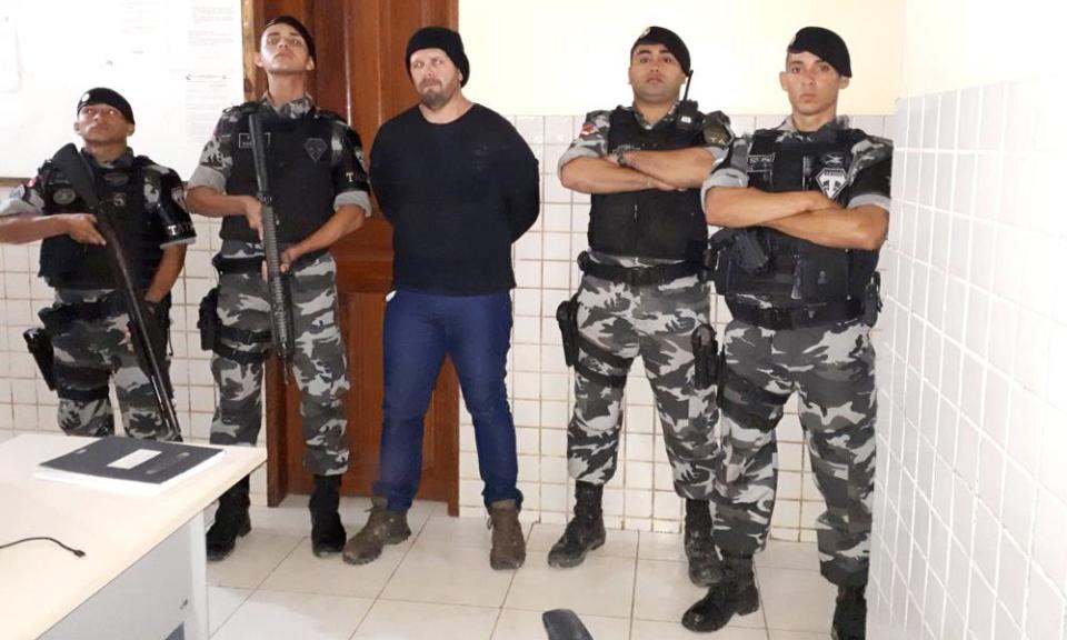 Brazilian military police stand with who they identify as Jose Irandir Cardoso – the man convicted in the killing of yachtsman Sir Peter Blake