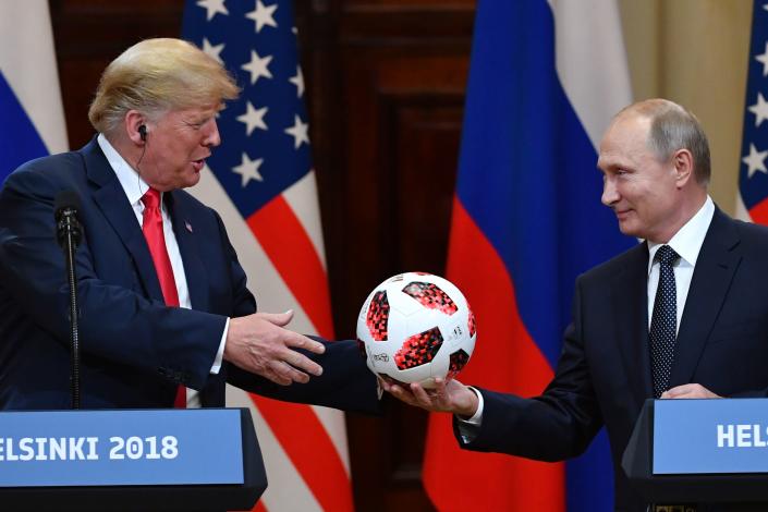 <p>Russia’s President Vladimir Putin offers a ball of the 2018 football World Cup to US President Donald Trump during a joint press conference after a meeting at the Presidential Palace in Helsinki, on July 16, 2018. (Photo: Yuri Kadobnov/AFP/Getty Images) </p>