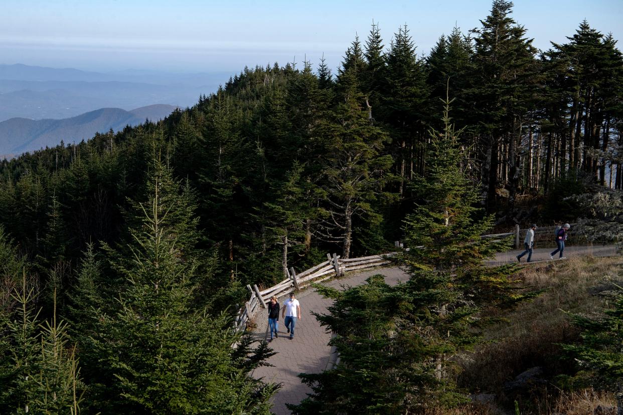 Visitors walk to and from the viewing platform at the summit at Mount Mitchell State Park on Oct. 19, 2020. 