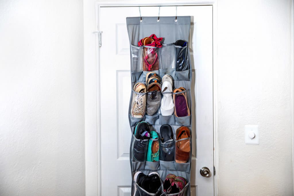 An over the door shoe organizer is shown in a person's home.