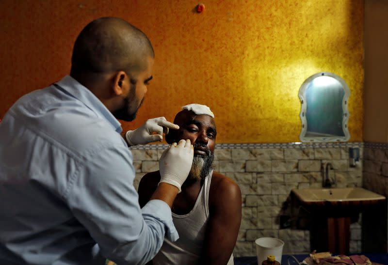 A Muslim man is treated at Al Hind hospital after he was injured in a clash between people demonstrating for and against a new citizenship law in a riot affected area in New Delhi