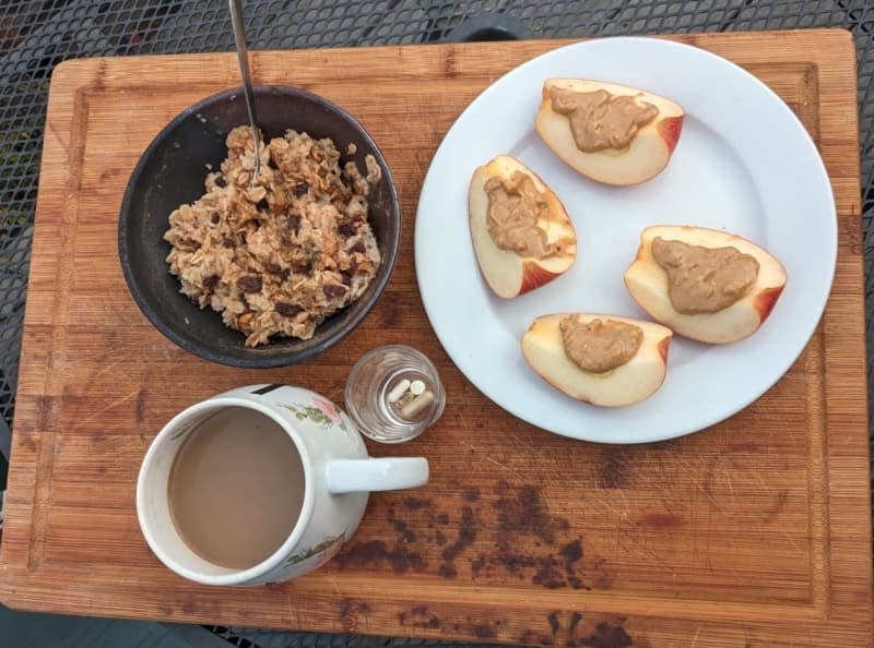 apple slices with peanut butter, cup of coffee, bowl of oatmeal