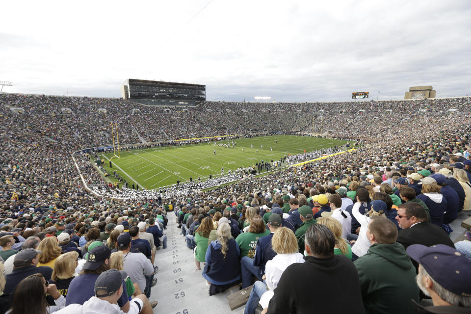 FILE - Notre Dame Stadium is shown during the second half of an NCAA college football game between Notre Dame and Michigan State in South Bend, Ind., Saturday, Sept. 21, 2013. What is most commonly referred to as major college football (aka NCAA Division I Bowl Subdivision or FBS) is compromised of 130 teams and 10 conferences. Seventy-seven of those teams are scheduled to play throughout the fall, starting at various times in September. The other 53, including the entire Big Ten and Pac-12, have postponed their seasons and are hoping to make them up later. That means no No. 2 Ohio State, No. 7 Penn State, No. 9 Oregon and six other teams that were ranked in the preseason AP Top 25. (AP Photo/Michael Conroy)