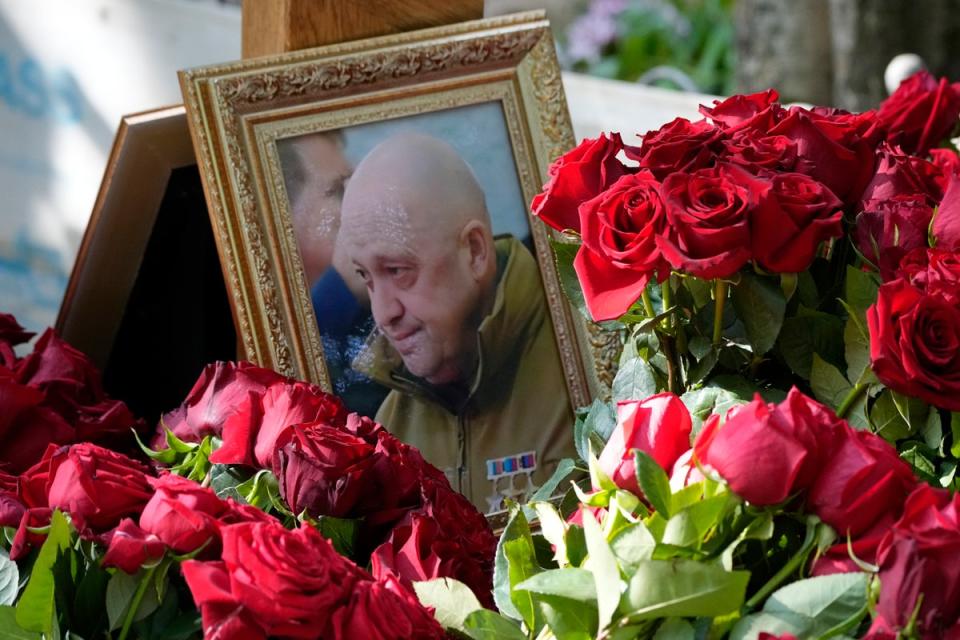 A portrait of Yevgeny Prigozhin lies on flowers on the grave at the Porokhovskoye cemetery in St. Petersburg, Russia (Copyright 2023 The Associated Press. All rights reserved)