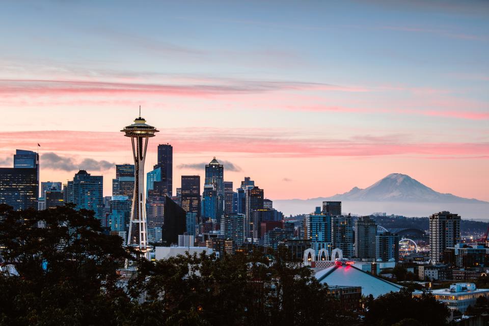 The Seattle skyline at dawn with Mount Rainier in the background.