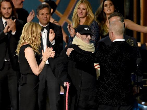 Kramer (centre) accepts the Outstanding Television Movie award at the Emmys in 2014 (Getty)