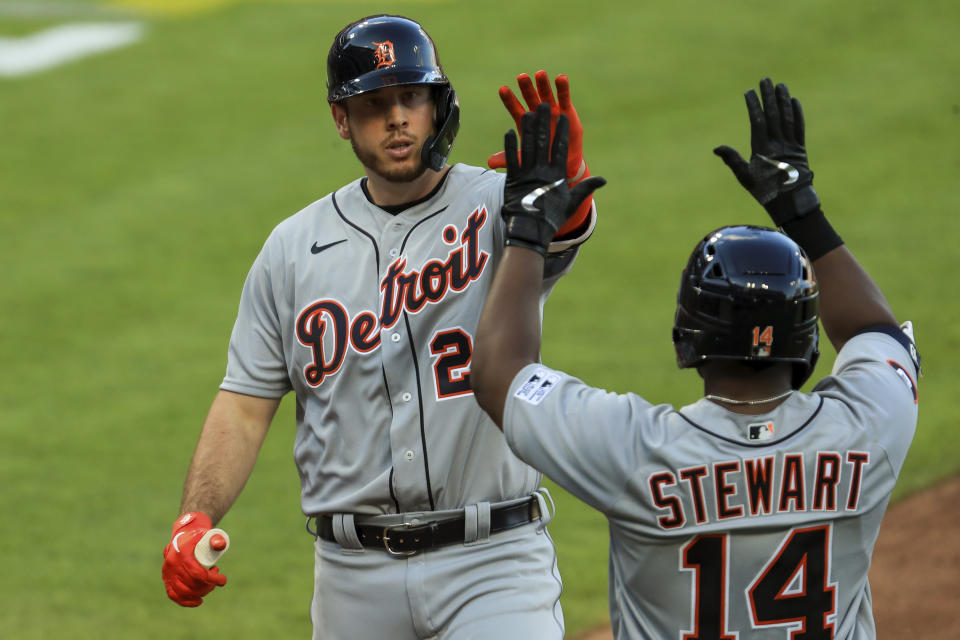Detroit Tigers' C.J. Cron (26) celebrates with Christin Stewart (14) after hitting a solo home run in the fourth inning of a baseball game against the Cincinnati Reds at Great American Ballpark in Cincinnati, Friday, July 24, 2020. (AP Photo/Aaron Doster)