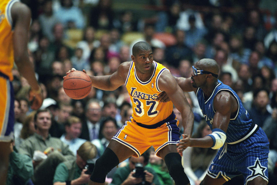 Magic Johnson of the Los Angeles Lakers with the ball as Horace Grant of the Orlando Magic defends during a National Basketball Association game at the Great Western Forum in Los Angeles, CA. (Photo by Matt A. Brown /Icon SMI/Icon Sport Media via Getty Images)