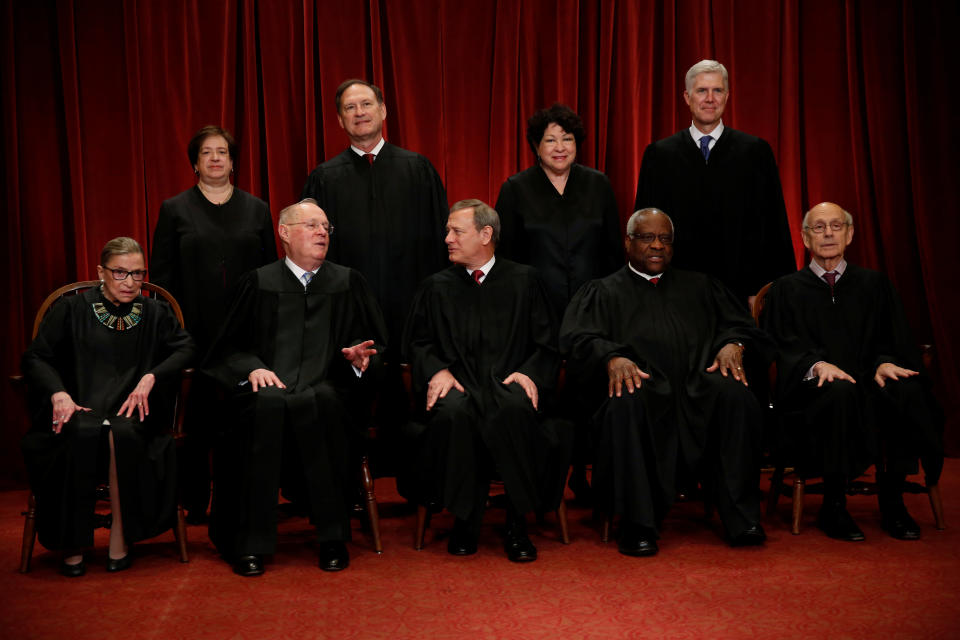 U.S. Chief Justice John Roberts (seated C) leads Justice Ruth Bader Ginsburg (front row, L-R), Justice Anthony Kennedy, Justice Clarence Thomas, Justice Stephen Breyer, Justice Elena Kagan (back row, L-R), Justice Samuel Alito, Justice Sonia Sotomayor, and Justice Neil Gorsuch in taking a new family photo including Gorsuch, their most recent addition, at the Supreme Court building in Washington, D.C., U.S., June 1, 2017.