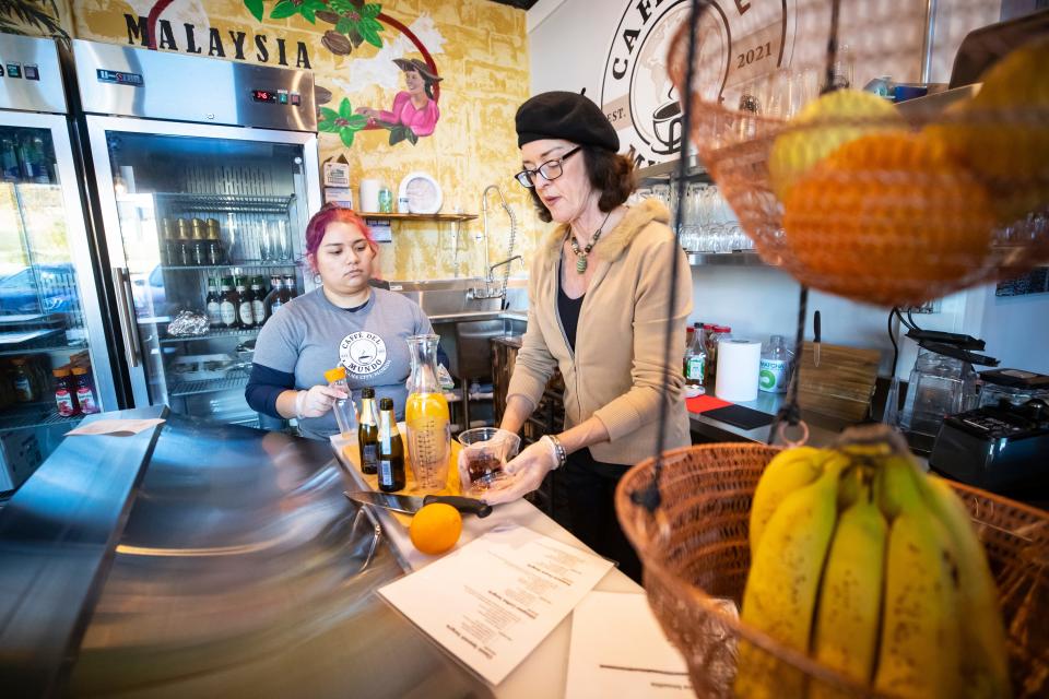 Caffé Del Mundo opened in the Cove area of Panama City this month serving espressos & teas, cold brews, smoothies and snacks, with sangria, wine and beer in the afternoons. Owner Marta Thorpe, right, works with Valerie Rosario to make a Prosecco Sangria drink.