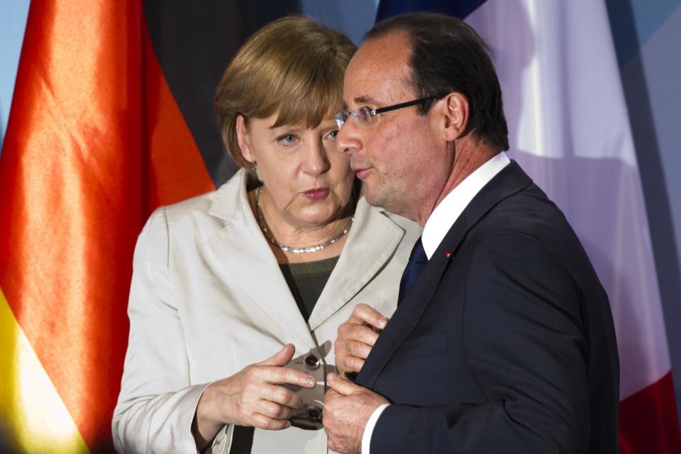 FILE - In this May 15, 2012 file photo, German Chancellor Angela Merkel, left, talks to new French President Francois Hollande in Berlin. President Barack Obama will play host this weekend to an extraordinary confluence of international summitry, with world leaders scuttling from the Maryland mountains to downtown Chicago as they grapple for fixes to Europe's mounting economic woes and solidify plans for winding down the decade-long war in Afghanistan. (AP Photo/Markus Schreiber, File)