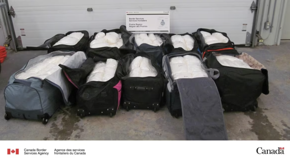 Two-hundred individually wrapped packages of drugs were found in large suitcases inside the semi-trailer, Ken MacGregor of the CBSA said. (Submitted by the CBSA)