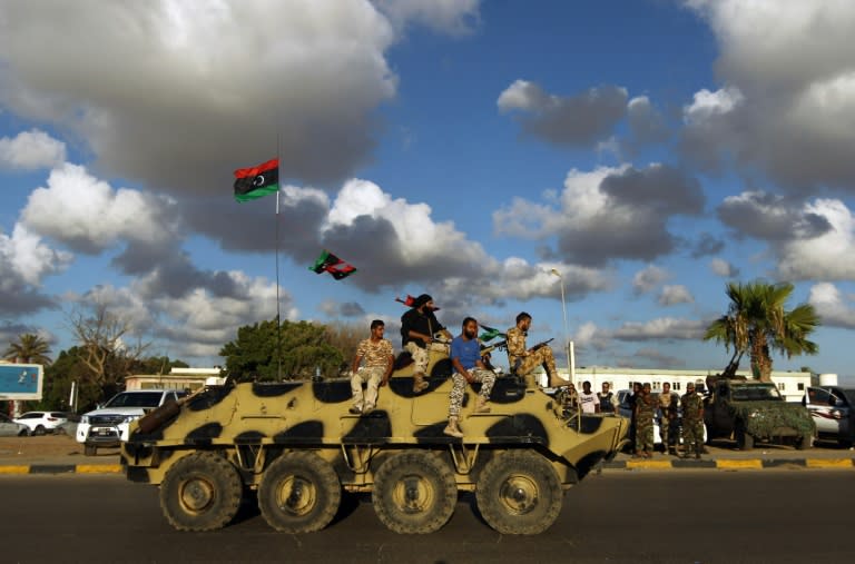 Libyan troops sit on an amoured personnel carrier during a demonstration calling on the international community to arm the Libyan army, on August 14, 2015 in Benghazi