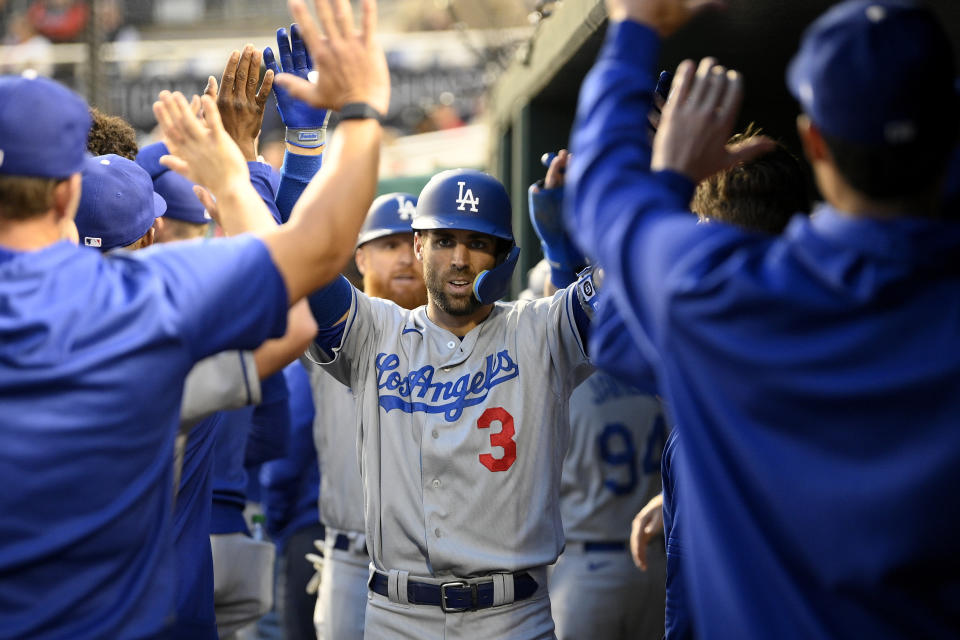 Los Angeles Dodgers' Chris Taylor celebrates his two-run home run during the third inning of a baseball game against the Washington Nationals, Tuesday, May 24, 2022, in Washington. (AP Photo/Nick Wass)