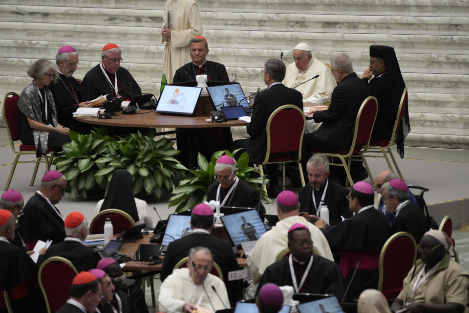 Pope Francis, sitting at top third from right, participates into the opening session of the 16th General Assembly of the Synod of Bishops in the Paul VI Hall at The Vatican, Wednesday, Oct. 4, 2023. Pope Francis is convening a global gathering of bishops and laypeople to discuss the future of the Catholic Church, including some hot-button issues that have previously been considered off the table for discussion. Key agenda items include women's role in the church, welcoming LGBTQ+ Catholics, and how bishops exercise authority. For the first time, women and laypeople can vote on specific proposals alongside bishops. (AP Photo/Gregorio Borgia)