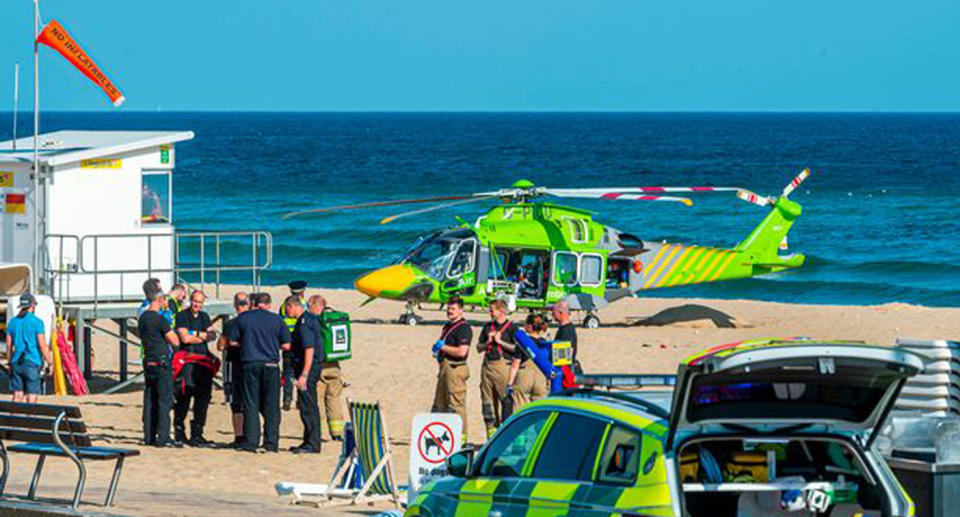 Emergency services standing on Bournemouth beach after the kids were pulled from the water.