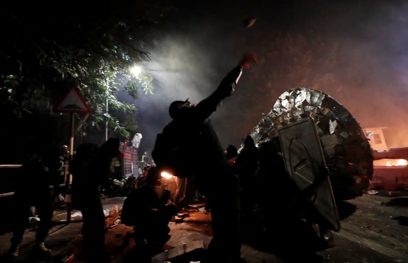 A protesters throws a molotov cocktail during a standoff with riot police at the Chinese University of Hong Kong