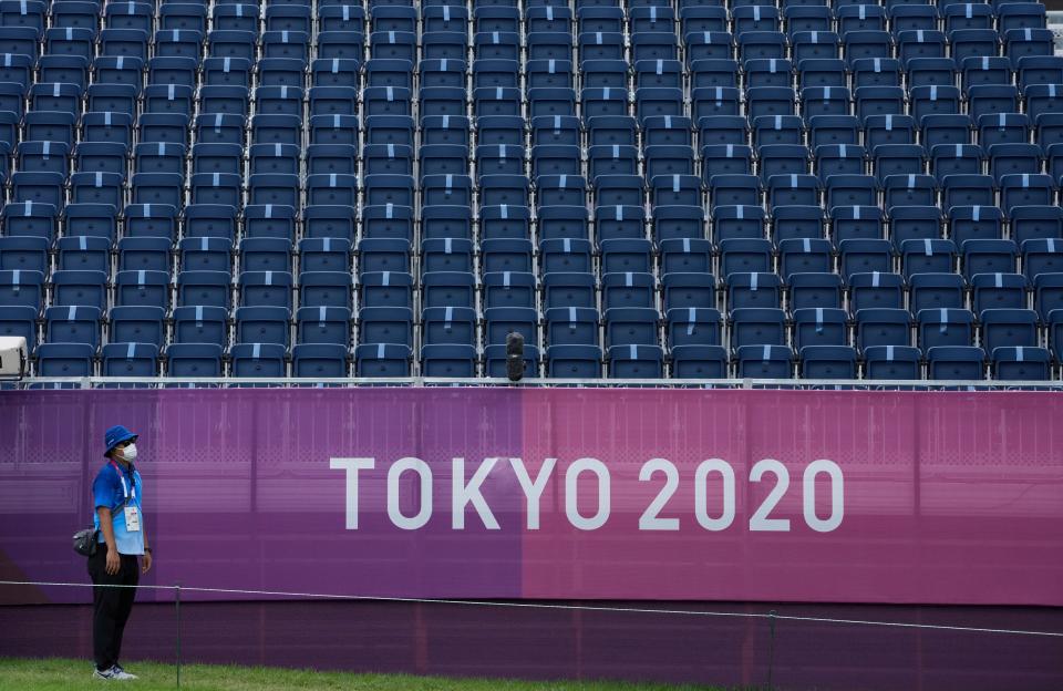 Empty stands and masked volunteers have become familiar sights at the Games. (AP)