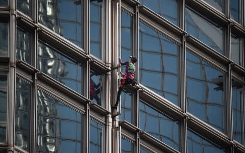 French urban climber Alain Robert, popularly known as the "French Spiderman", climbs the Cheung Kong Center building in Hong Kong - Credit: AFP