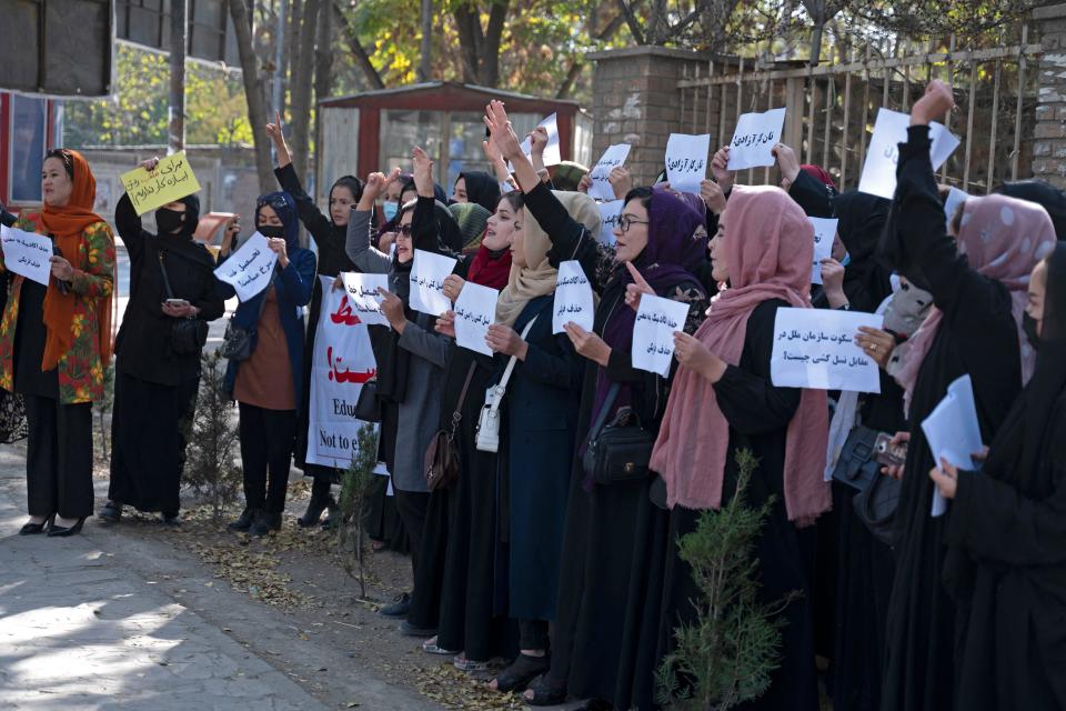 Afghan women hold placards during a protest in front of Kabul University,  in Afghanistan's capital, October 18, 2022. / Credit: AFP/Getty