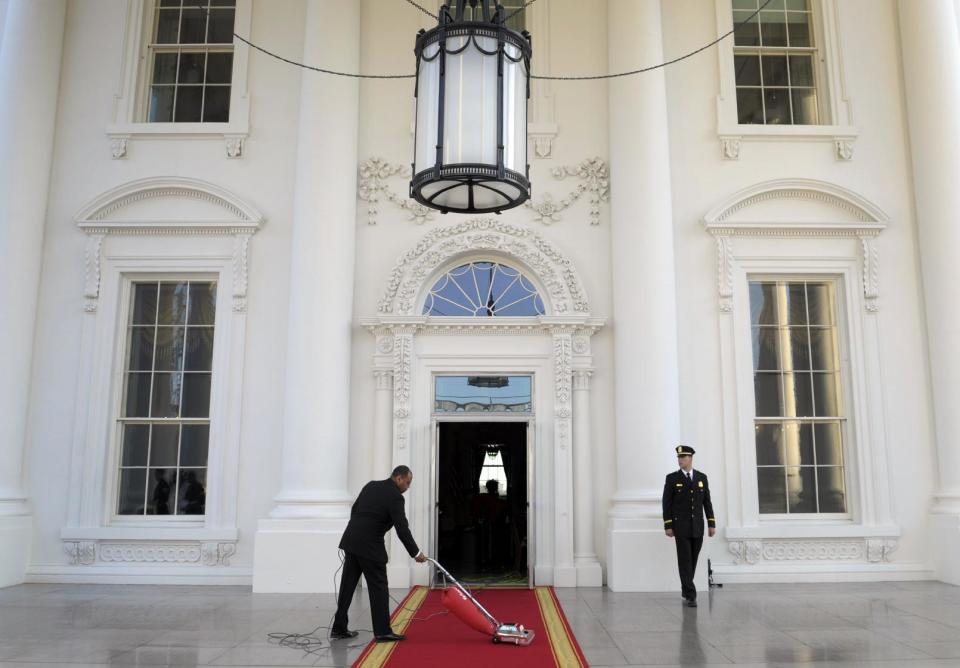 FILE - In this March 14, 2012, file photo, the red carpet of the North Portico is prepared for President Barack Obama and first lady Michelle Obama to welcome Britain's Prime Minister David Cameron and his wife Samantha to the White House for a State Dinner in Washington. Obama is using privileged access to one of America’s greatest landmarks to reward his most generous financial supporters in ways that Republicans Mitt Romney and Rick Santorum can’t match: More than 60 of Obama’s biggest campaign donors have visited the White House more than once for meetings with top advisers, holiday parties or state dinners, a review by The Associated Press has found. (AP Photo/Susan Walsh, File)