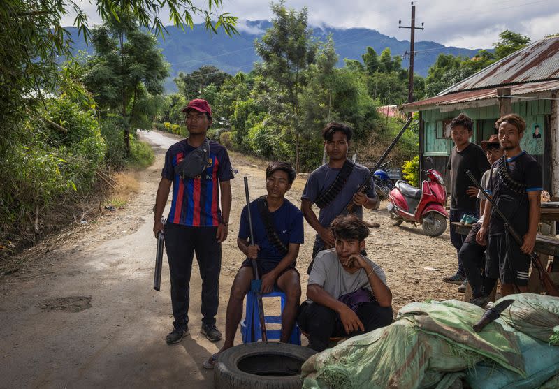 Armed Kuki men guard a checkpoint at Torbung village