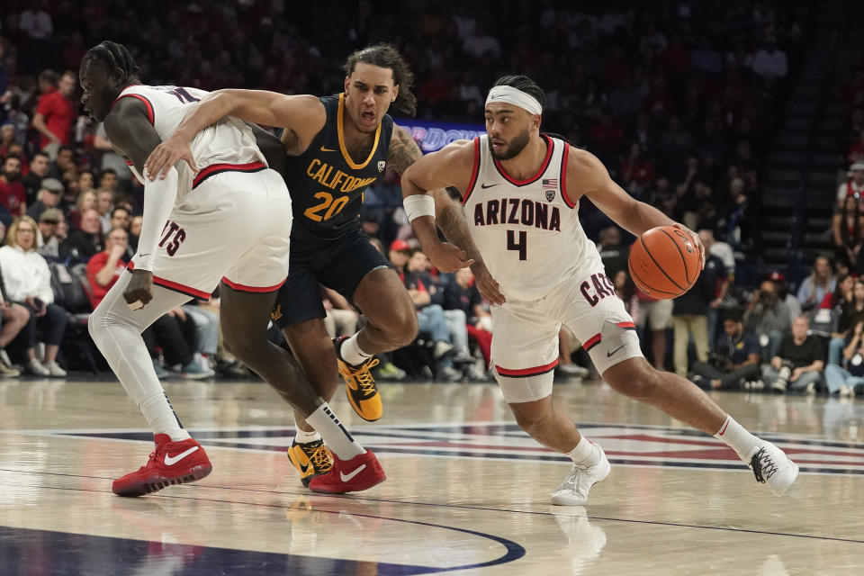 California's Bevin Curtis (20) gets blocked by Arizona's Oumar Ballo, left, as Kylan Boswell (4) dribbles towards the basket during the second half of an NCAA college basketball game Thursday, Feb. 1, 2024, in Tucson, Ariz. (AP Photo/Darryl Webb)