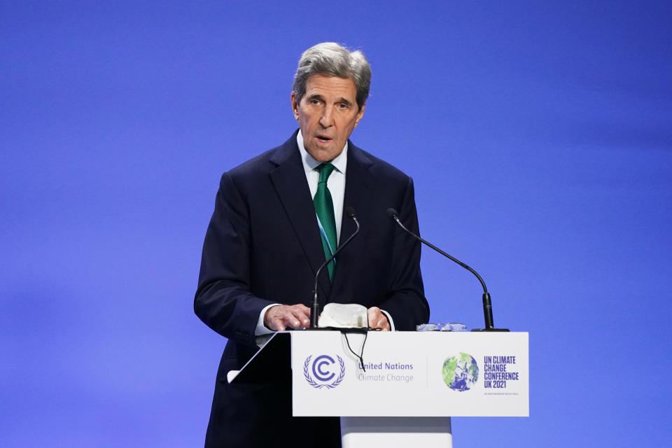 Special presidential envoy for climate John Kerry stands at a podium as he speaks at a press conference at COP26 in Glasgow, Scotland.