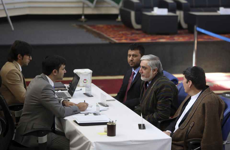 Afghanistan Chief Executive Abdullah Abdullah, right, center, registers his presidential candidacy along with Enayatullah Babur Farahmand, left, as the first vice president and Asadullah Sahadati, right, as the second voice president, during a ceremony in Kabul, Afghanistan, Sunday, Jan. 20, 2019. Ghani and Chief Executive Abdullah Abdullah on Sunday registered to run for president later this year, setting up a rematch after a bitterly disputed 2014 vote led to a power-sharing agreement brokered by the United States. (AP Photo/Rahmat Gul)